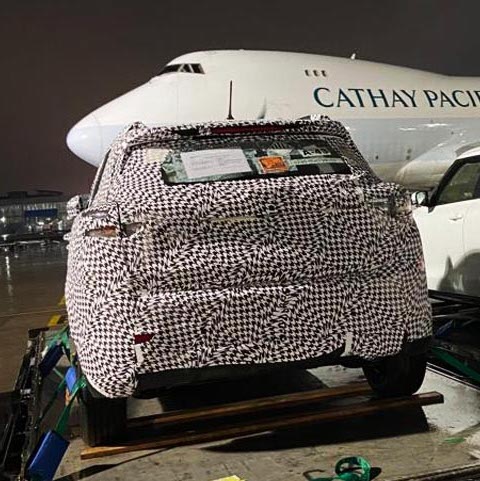 A car in dazzle camouflage loaded on board a Cathay Pacific Cargo freighter plane