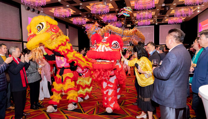 Members of the Cathay senior team dot the eyes of the lion and dragon as tradition dictates